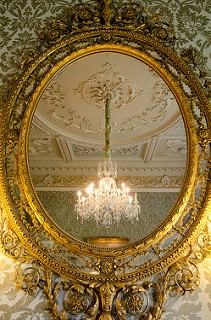 Gold Mirror reflecting chandelier in Morning Room at Hartwell House