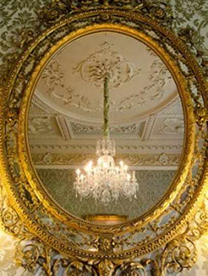 Gold Mirror reflecting chandelier in Morning Room at Hartwell House
