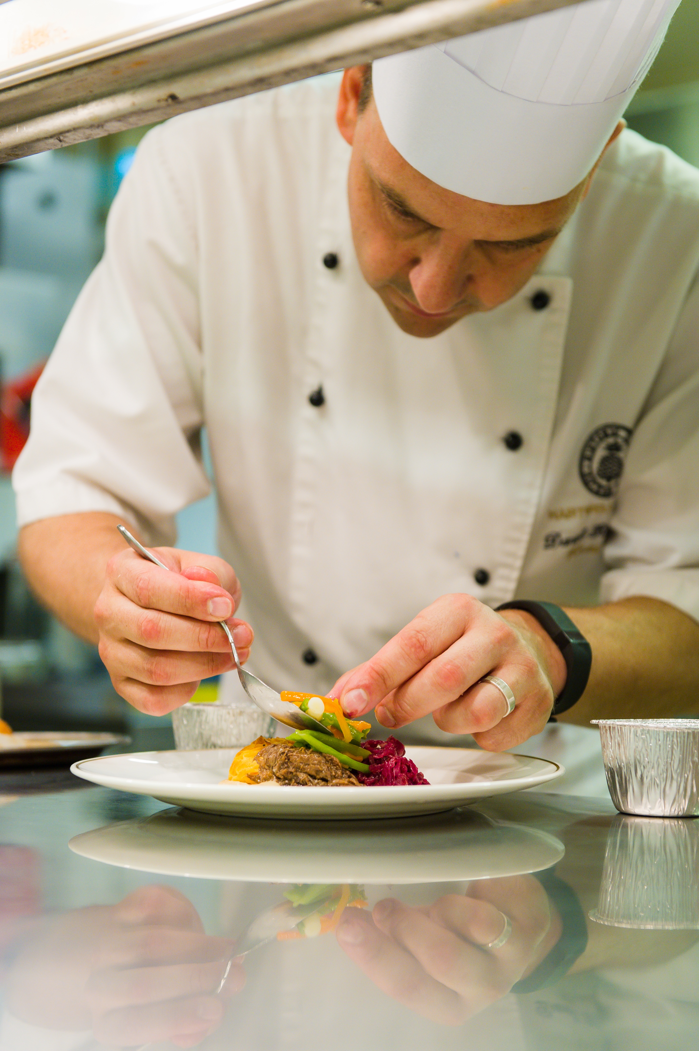 Head Chef puts finishing touch to dish for wedding at Hartwell House