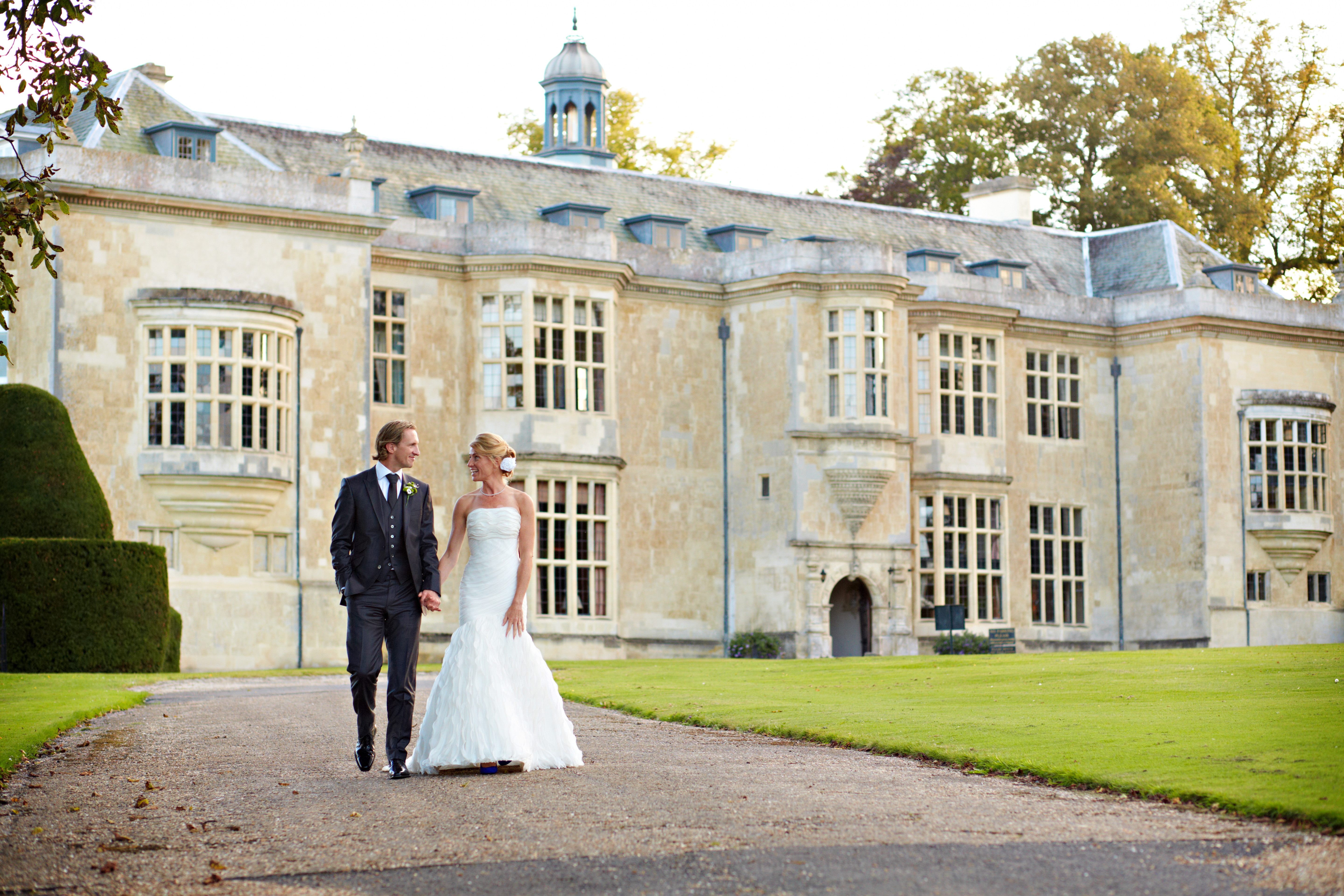 Bridal couple on drive outside Hartwell House