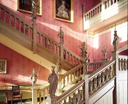 Staircase showing portraits of King Louis XVIII of France and his wife at Hartwell House 